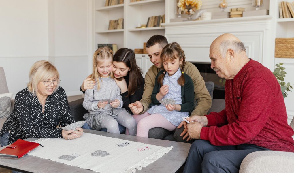 family gathers around a table, engrossed in board games