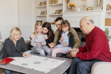 family gathers around a table, engrossed in board games