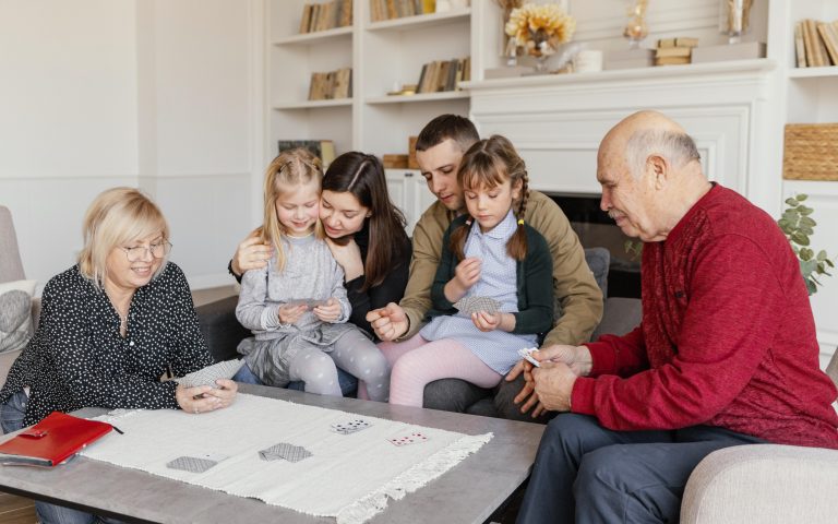 family gathers around a table, engrossed in board games