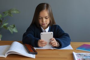 Screen time: A girl in using a tablet device for educational purpose 