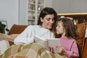 Bedtime Stories: Mother and child cuddled together with a book, sharing a special moment